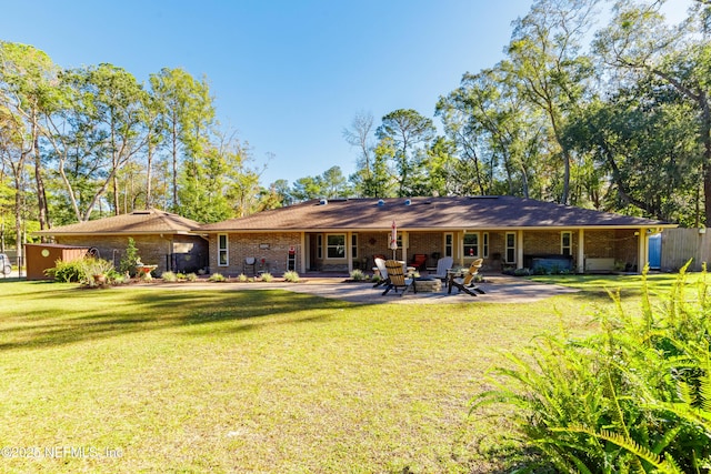 back of property with a patio and a lawn