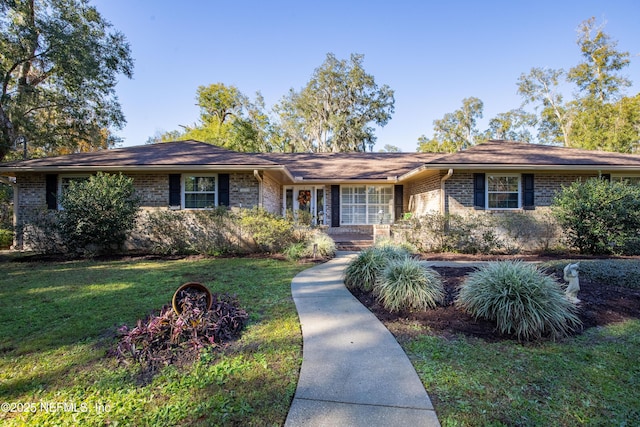 ranch-style home featuring a front yard