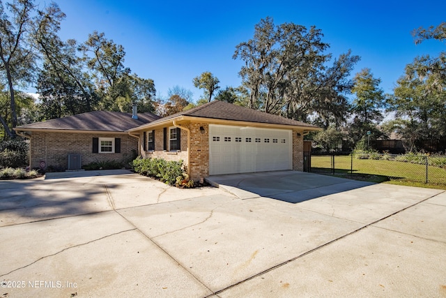 ranch-style house with cooling unit and a garage