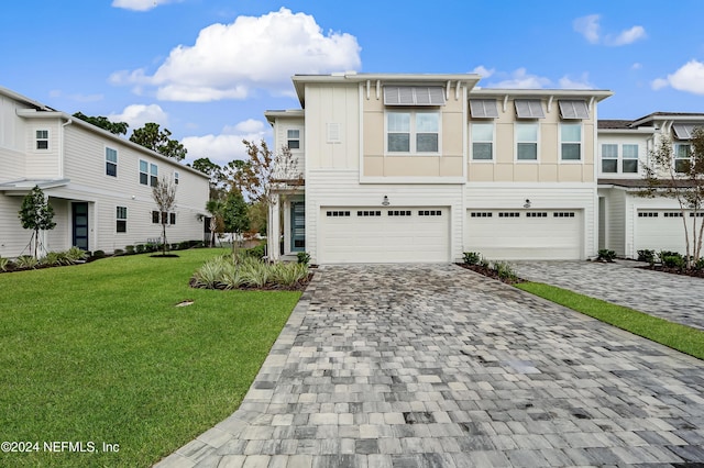 view of front of property featuring a garage and a front lawn