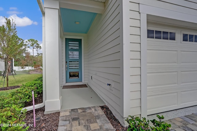 doorway to property with a garage