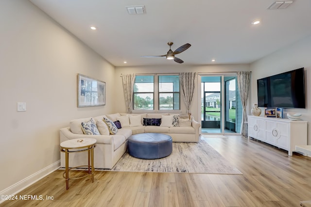 living room with ceiling fan and light wood-type flooring