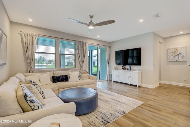 living room with ceiling fan and light wood-type flooring