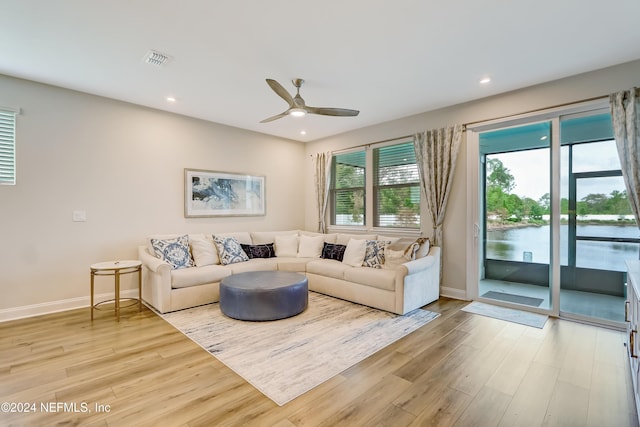 living room with ceiling fan and light wood-type flooring