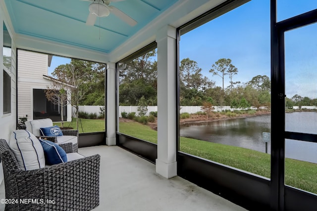 sunroom / solarium with a water view and ceiling fan