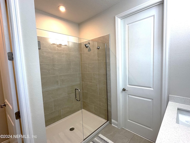 bathroom with sink and an enclosed shower