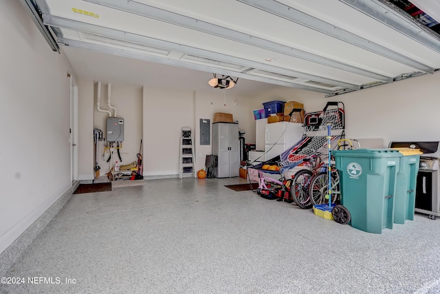 garage with a garage door opener, electric panel, and water heater