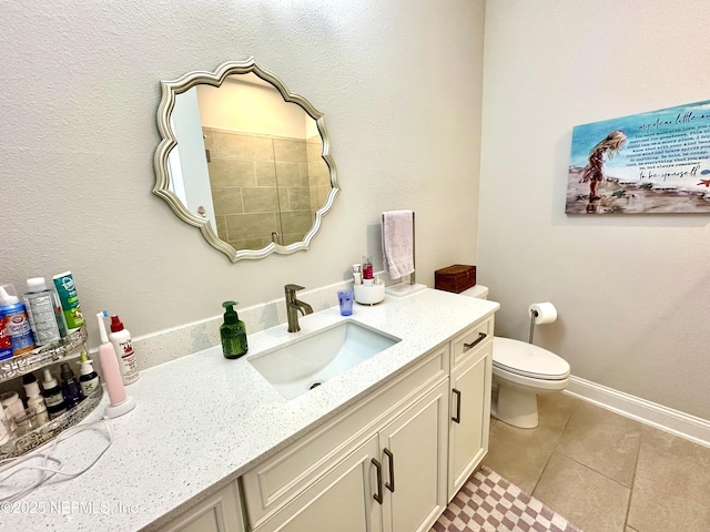 bathroom featuring vanity, tile patterned floors, and toilet