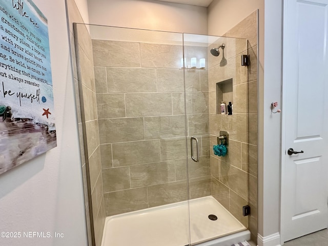 bathroom with a shower with shower door