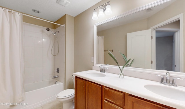 bathroom featuring double vanity, shower / tub combo, a sink, and toilet