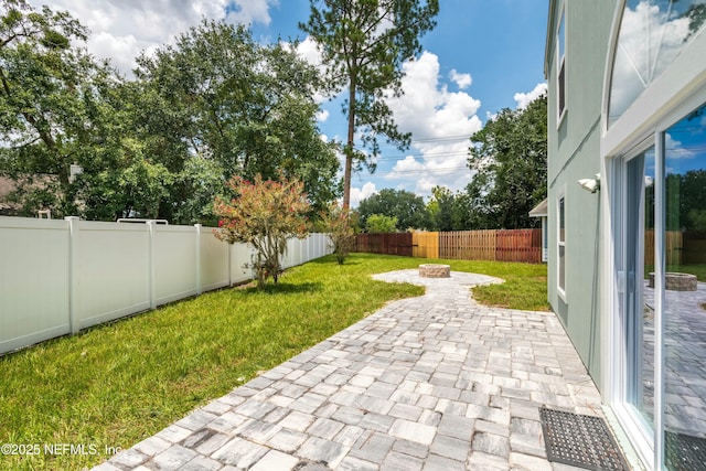 view of yard with a patio area and an outdoor fire pit