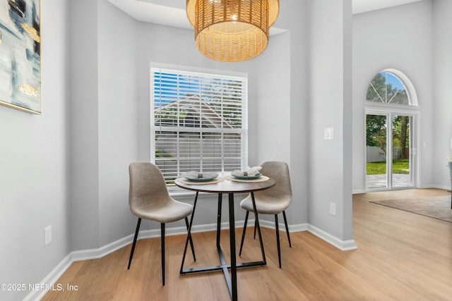 dining space featuring a chandelier and light wood-type flooring