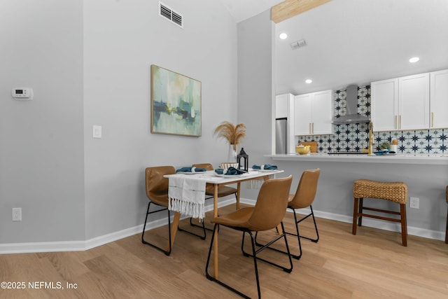 dining space with light hardwood / wood-style flooring