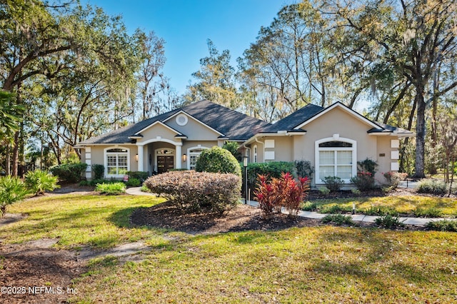 view of front of home featuring a front yard and stucco siding