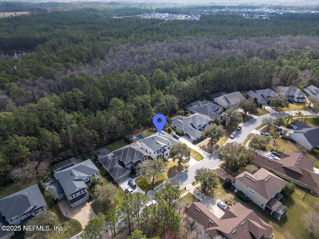 drone / aerial view with a residential view and a forest view