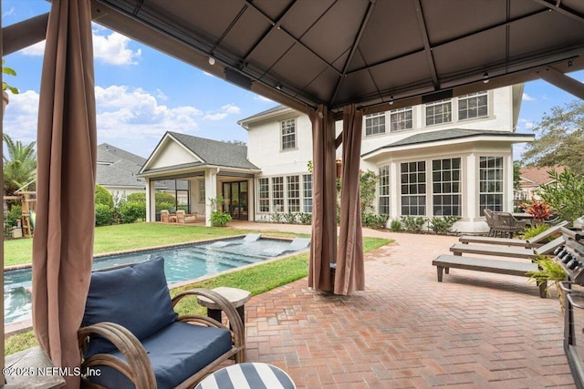 view of patio / terrace with a gazebo and an outdoor pool