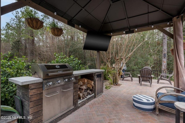 view of patio / terrace with a gazebo, area for grilling, and an outdoor kitchen