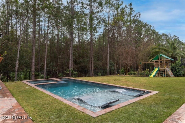 view of pool featuring a lawn, fence, a playground, a fenced in pool, and an in ground hot tub