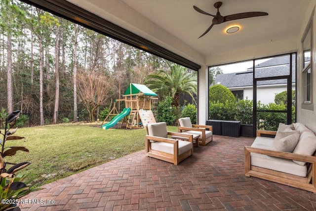 exterior space with an outdoor hangout area, a playground, a ceiling fan, and fence