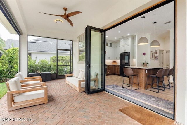 interior space with ceiling fan and outdoor dry bar