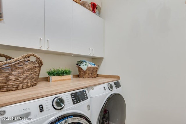 washroom featuring separate washer and dryer and cabinet space