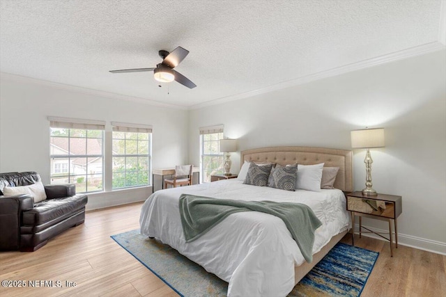 bedroom featuring baseboards, a textured ceiling, wood finished floors, and ornamental molding