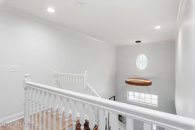hall with recessed lighting, an upstairs landing, and ornamental molding