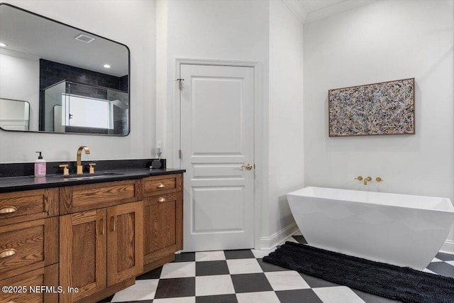 full bathroom featuring tile patterned floors, a freestanding tub, ornamental molding, a shower stall, and vanity