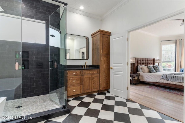 ensuite bathroom with tile patterned floors, a stall shower, ornamental molding, ensuite bath, and vanity