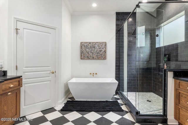 bathroom with vanity, tile patterned floors, a stall shower, and a freestanding bath