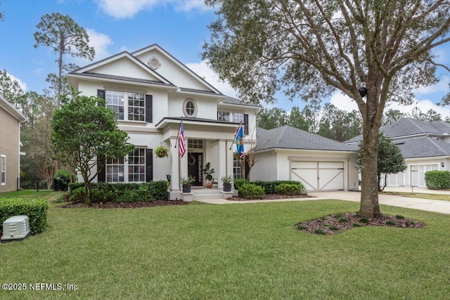 view of front of property featuring stucco siding, an attached garage, concrete driveway, and a front lawn