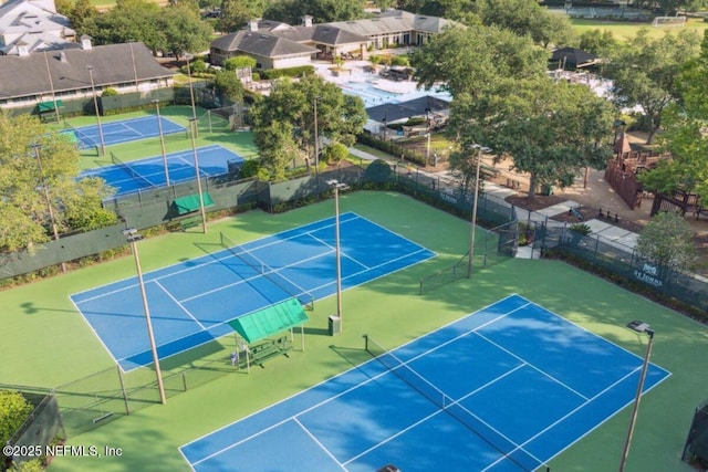 view of sport court featuring a residential view and fence