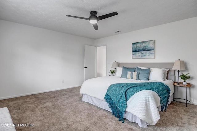 bedroom featuring carpet, a textured ceiling, and ceiling fan