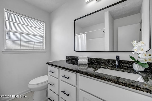 bathroom with vanity, toilet, a shower with shower curtain, and a textured ceiling