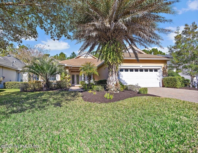 view of front of house featuring a garage and a front lawn