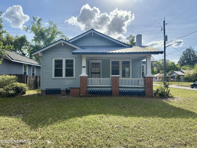 6624 Avalon St, Jacksonville, FL 32208 - bungalow-style home with a front lawn, metal roof, covered porch, and fence