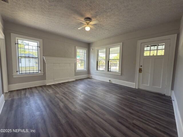 6624 Avalon St, Jacksonville, FL 32208 - foyer entrance with baseboards, a textured ceiling, a ceiling fan, and dark wood finished floors