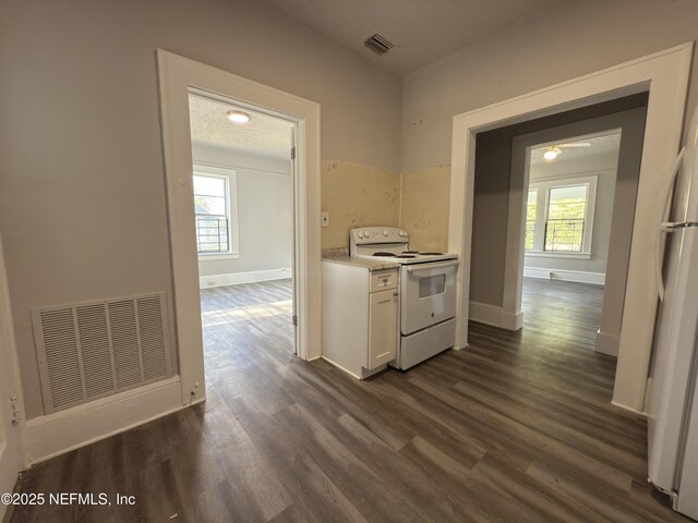 6624 Avalon St, Jacksonville, FL 32208 - kitchen with dark wood finished floors, visible vents, and white appliances