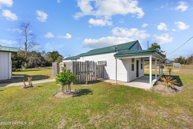 back of property with a yard and a patio