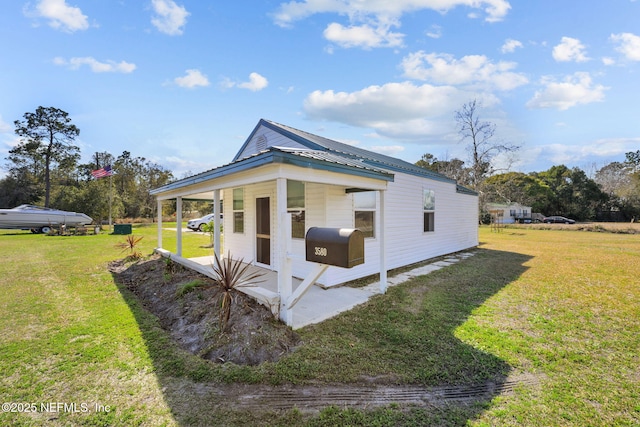 view of side of home with a yard