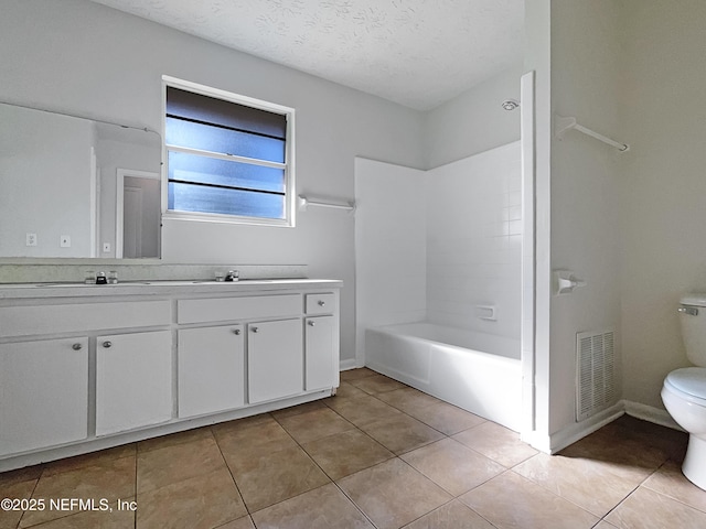 full bath with a textured ceiling, tile patterned flooring, toilet, visible vents, and double vanity