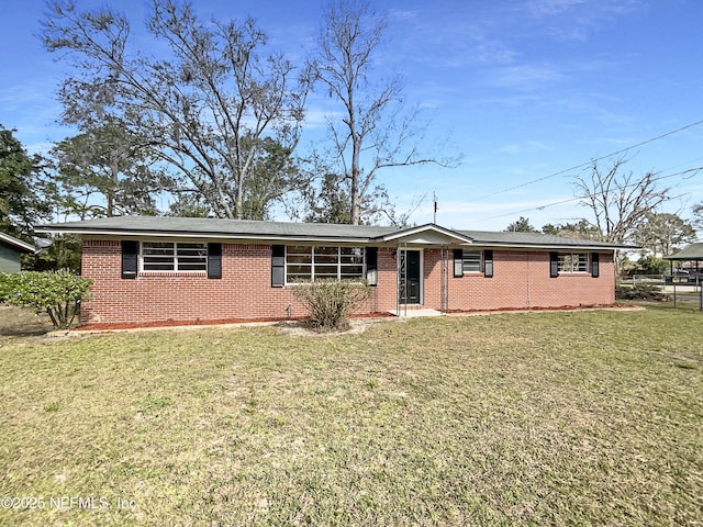 single story home with brick siding and a front yard