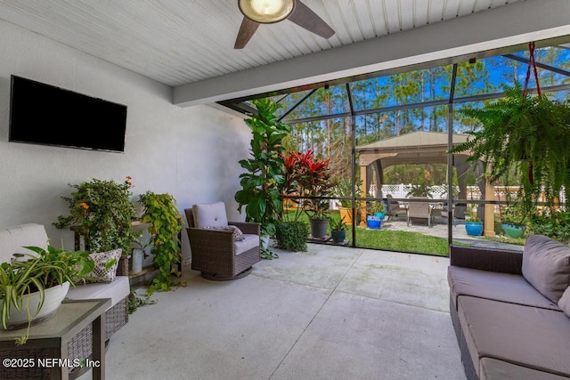 view of patio featuring a gazebo, ceiling fan, and an outdoor living space