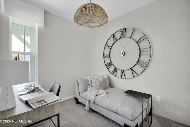 carpeted bedroom with brick wall