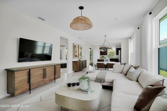 living room with light tile patterned floors and a chandelier