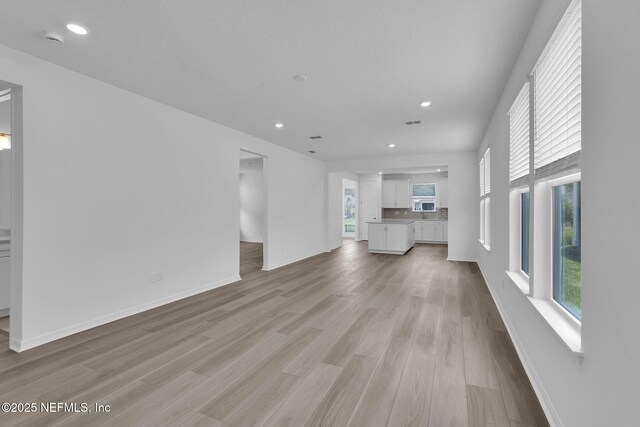 232 Fairlake Cir, Saint Augustine, FL 32092 - unfurnished living room featuring light wood-type flooring and recessed lighting