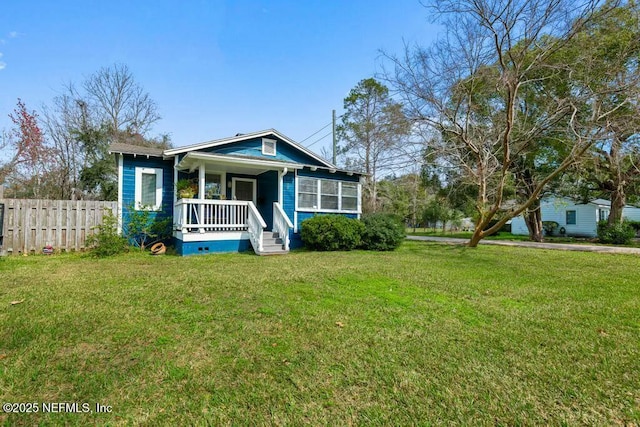 view of front of home with a porch and a front lawn