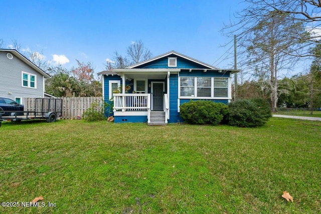 bungalow with a porch and a front lawn