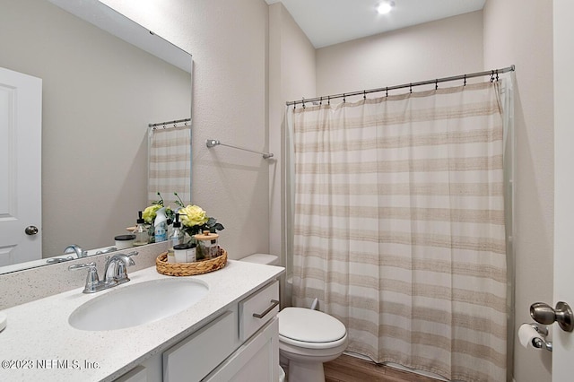 full bath with vanity, wood finished floors, toilet, and a shower with curtain