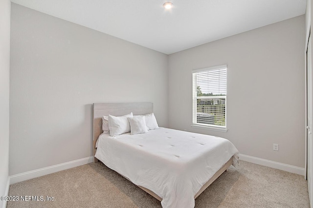 carpeted bedroom with baseboards